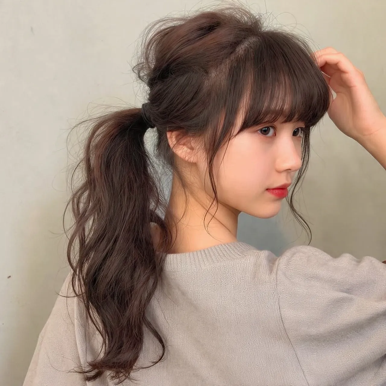 25 Messy Ponytail Hairstyles Ideas for Effortless Beauty and Style 3 Messy Ponytail with Curtain Bangs Ideas